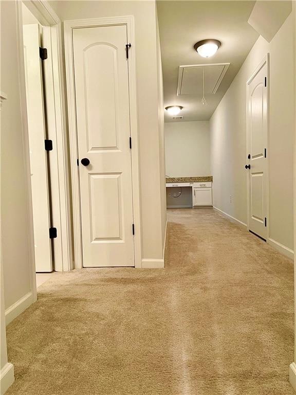 hallway featuring light carpet