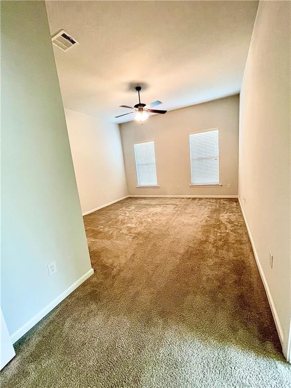 empty room featuring carpet and ceiling fan