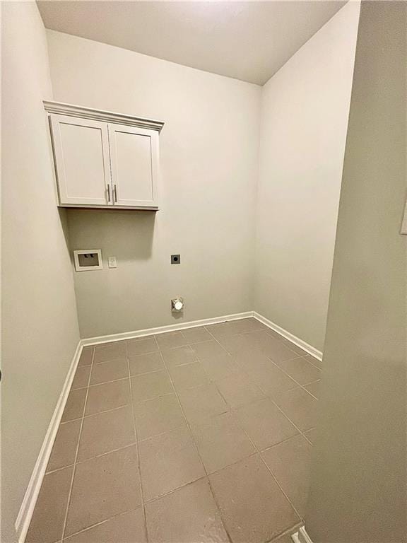 laundry room with tile patterned floors, hookup for a washing machine, electric dryer hookup, and cabinets