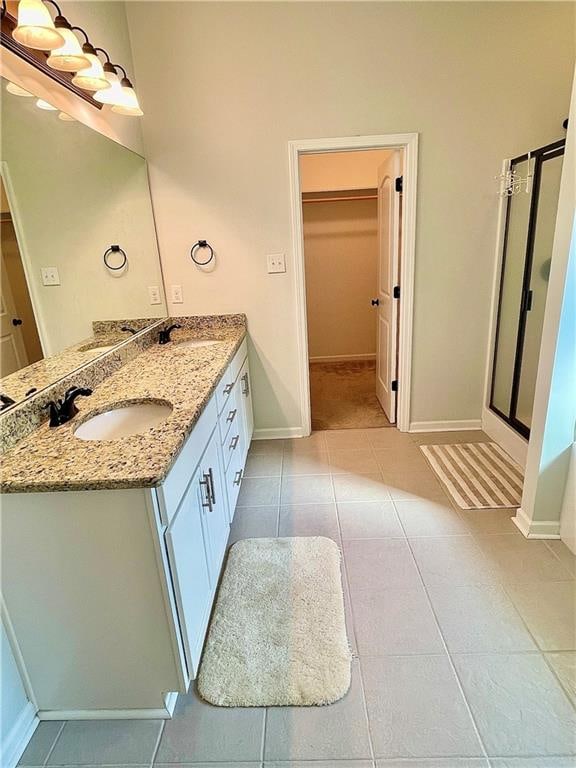 bathroom with vanity, tile patterned floors, and an enclosed shower