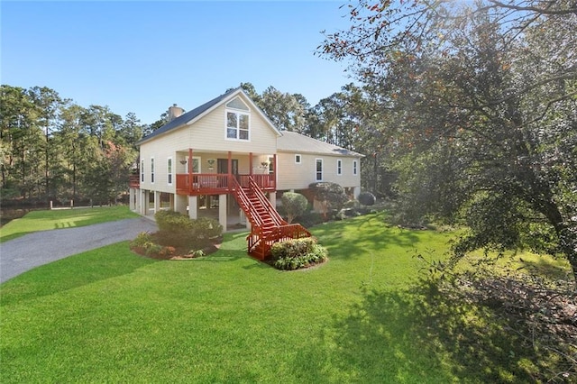 view of front facade featuring a front lawn and a deck