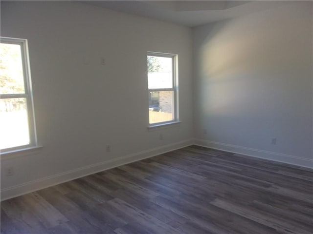 spare room with dark wood-type flooring