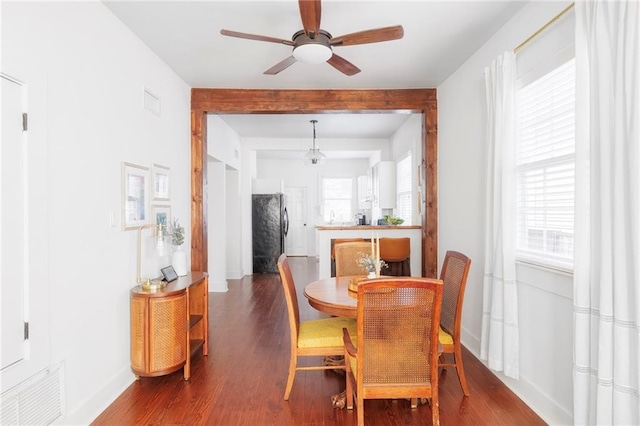 dining area with ceiling fan and wood-type flooring