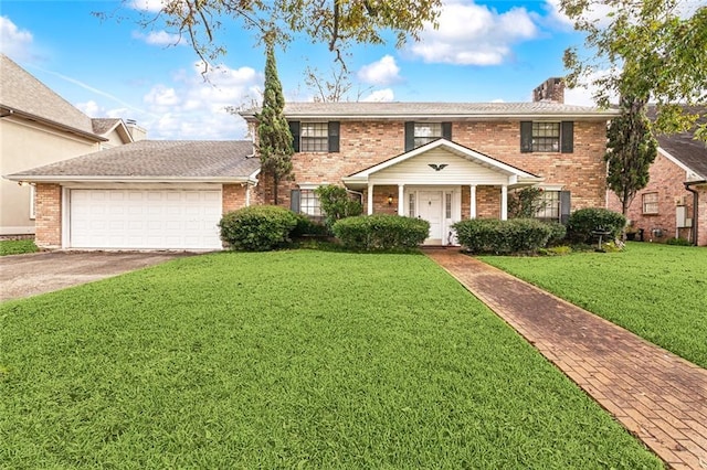 view of front of house featuring a front yard and a garage