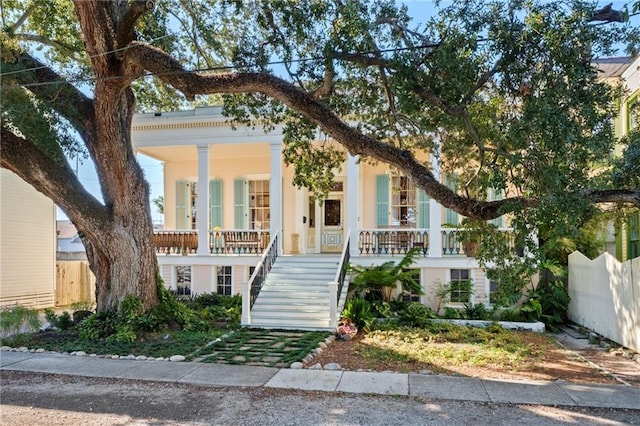 neoclassical / greek revival house featuring covered porch