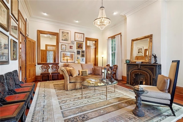 sitting room featuring hardwood / wood-style floors, crown molding, and a chandelier