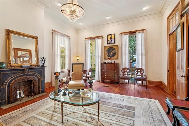 sitting room with crown molding, dark hardwood / wood-style floors, and a chandelier