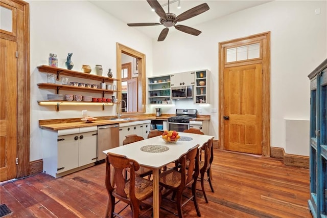 kitchen featuring white cabinetry, stainless steel appliances, dark wood-type flooring, and sink