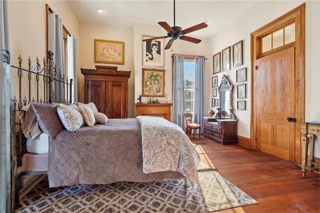 bedroom featuring ceiling fan and dark hardwood / wood-style flooring