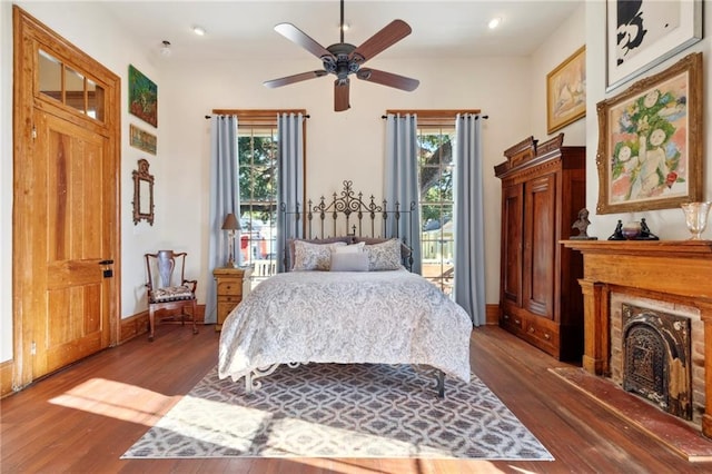 bedroom featuring ceiling fan, access to exterior, and dark hardwood / wood-style flooring