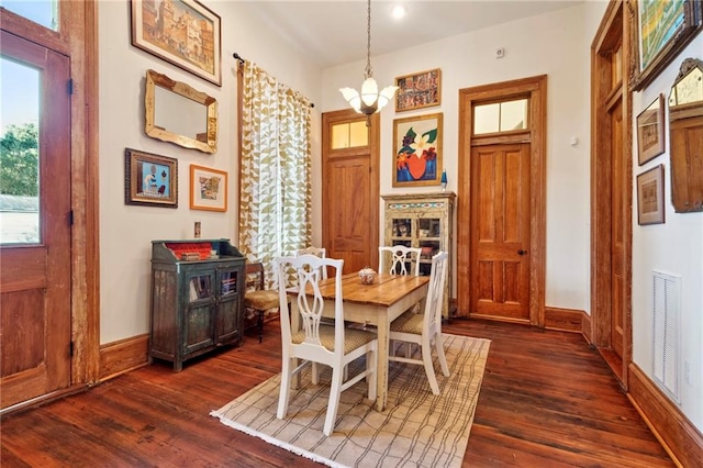 dining room featuring a notable chandelier and dark hardwood / wood-style floors