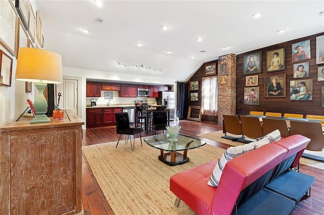 living room with hardwood / wood-style flooring and vaulted ceiling