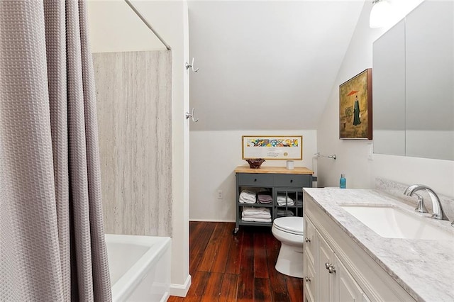 full bathroom featuring lofted ceiling, wood-type flooring, toilet, shower / bath combo with shower curtain, and vanity