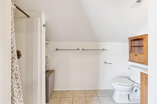 bathroom featuring vanity, tile patterned floors, toilet, and walk in shower