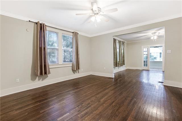 spare room featuring crown molding, dark hardwood / wood-style floors, and ceiling fan