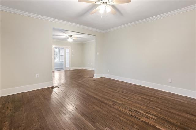 empty room featuring ornamental molding, dark hardwood / wood-style floors, and ceiling fan