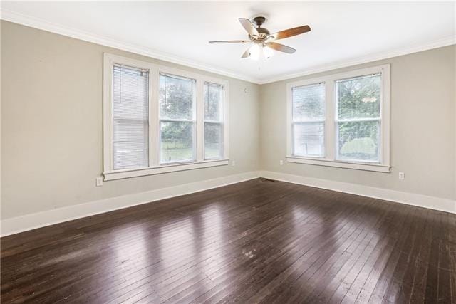 spare room with crown molding, dark hardwood / wood-style floors, and ceiling fan