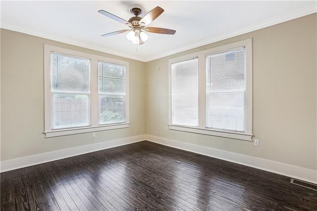 unfurnished room featuring crown molding, dark hardwood / wood-style floors, and ceiling fan