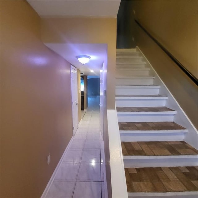 stairway with tile patterned floors