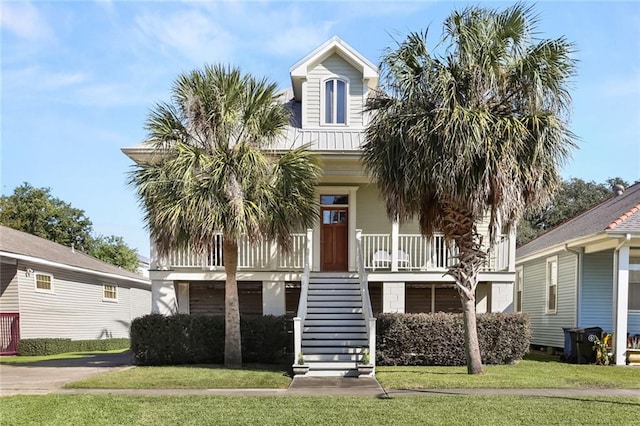 coastal home featuring a front lawn