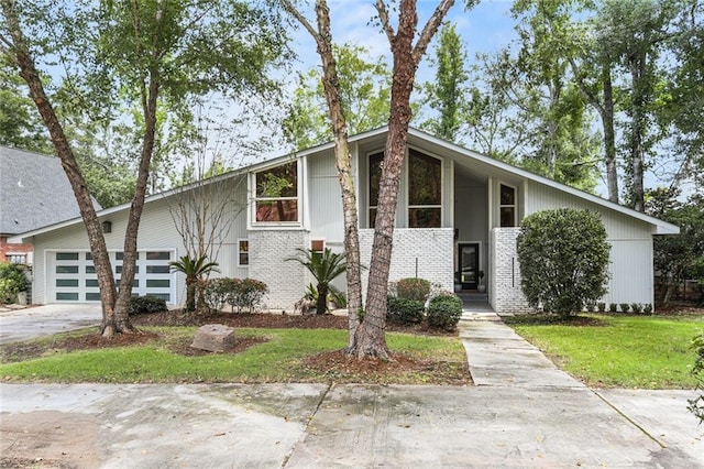 view of front of home with a garage and a front yard