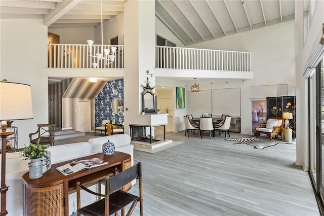 interior space with wood-type flooring, a notable chandelier, wooden ceiling, high vaulted ceiling, and beam ceiling