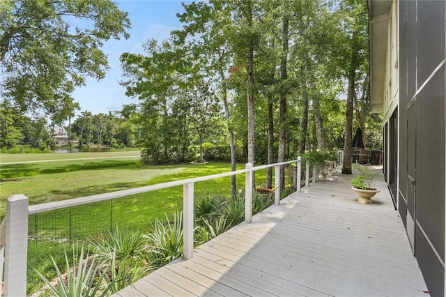 wooden deck featuring a yard