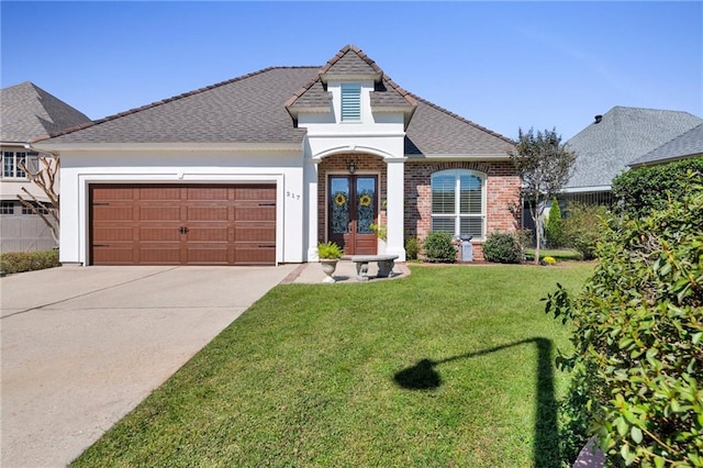 view of front of home featuring a garage and a front lawn