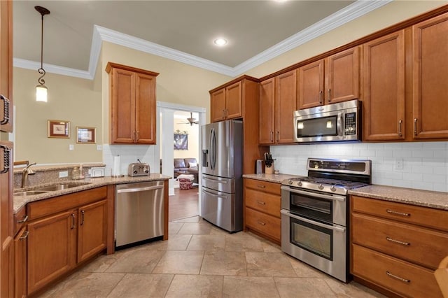 kitchen featuring appliances with stainless steel finishes, ornamental molding, light stone countertops, and sink