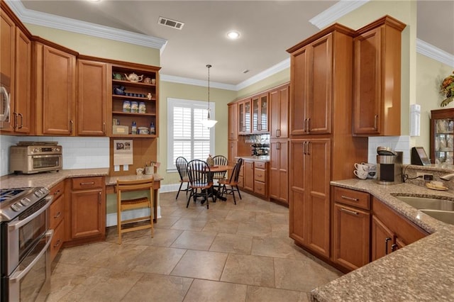 kitchen with pendant lighting, crown molding, sink, and stainless steel range