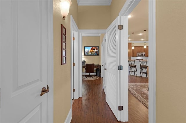 hallway featuring crown molding and dark wood-type flooring