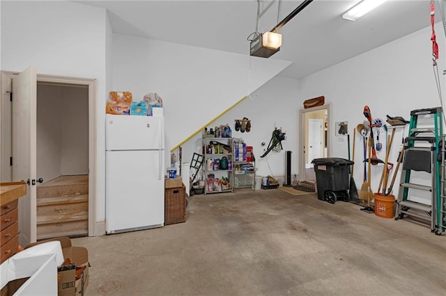 garage featuring a garage door opener and white fridge