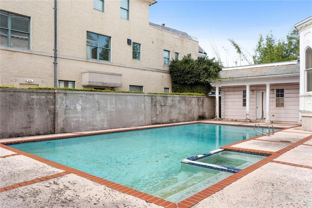 view of swimming pool with an in ground hot tub and a patio area