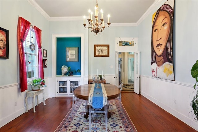 dining area with dark wood-style floors, ornamental molding, and an inviting chandelier