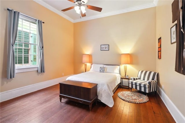 bedroom with dark wood-style floors, crown molding, baseboards, and ceiling fan