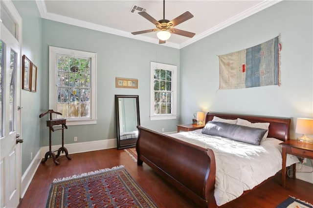 bedroom featuring dark wood-style floors, crown molding, visible vents, ceiling fan, and baseboards