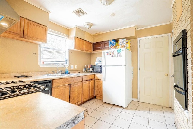 kitchen with ornamental molding, sink, white fridge, and light tile patterned floors