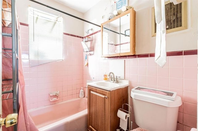 full bathroom with tile walls, vanity, toilet, and shower / bathtub combination with curtain