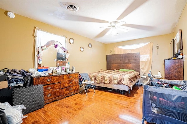 bedroom with ceiling fan and light hardwood / wood-style floors