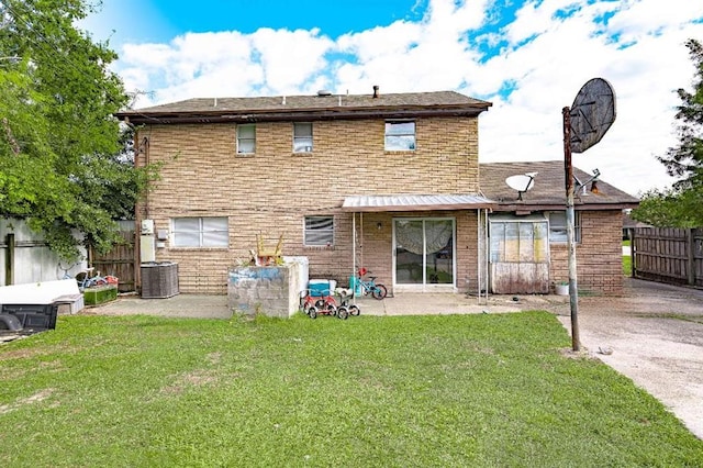 back of property with a patio area, cooling unit, and a yard