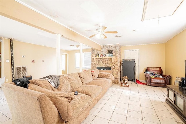 tiled living room featuring ornamental molding, a fireplace, and ceiling fan