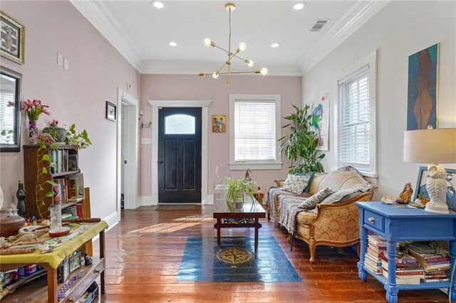 living room with crown molding, a wealth of natural light, and light wood-type flooring