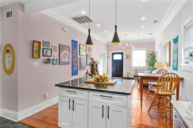 kitchen with crown molding and visible vents