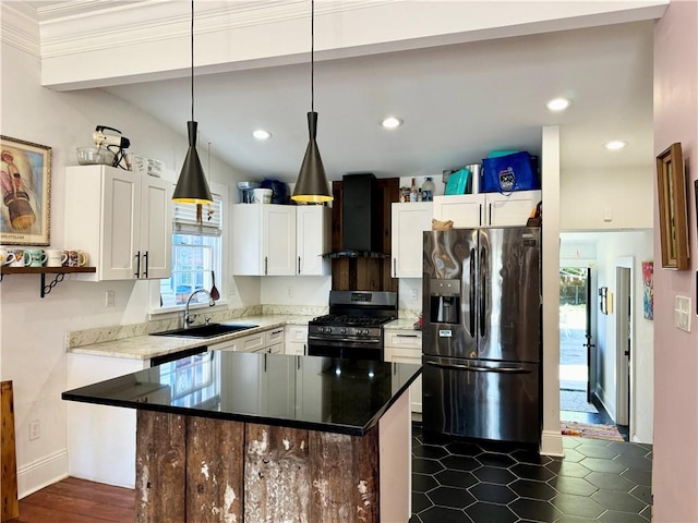 kitchen with refrigerator with ice dispenser, a sink, gas stove, wall chimney exhaust hood, and white cabinets