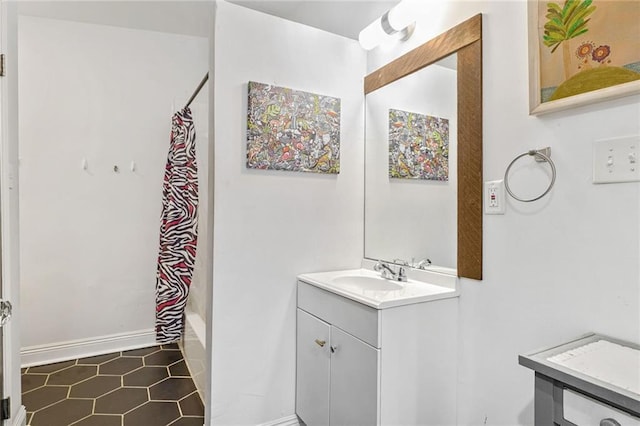 bathroom featuring vanity, tile patterned floors, curtained shower, and baseboards