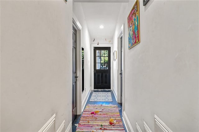 doorway to outside featuring recessed lighting and baseboards