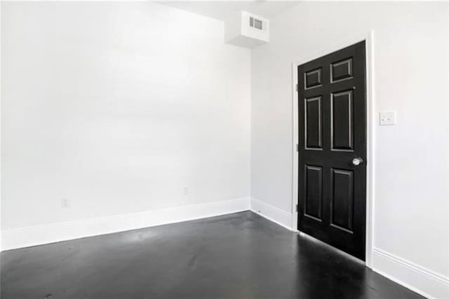 unfurnished room featuring visible vents, baseboards, and finished concrete floors