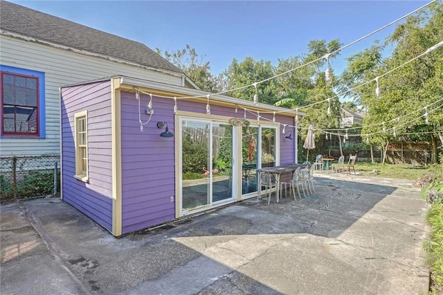 view of outbuilding featuring fence