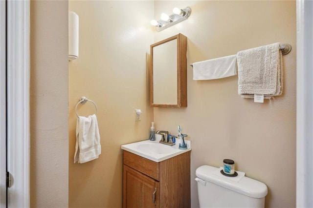 bathroom featuring toilet and vanity