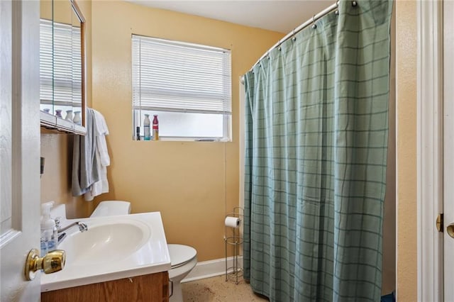 bathroom featuring curtained shower, vanity, and toilet